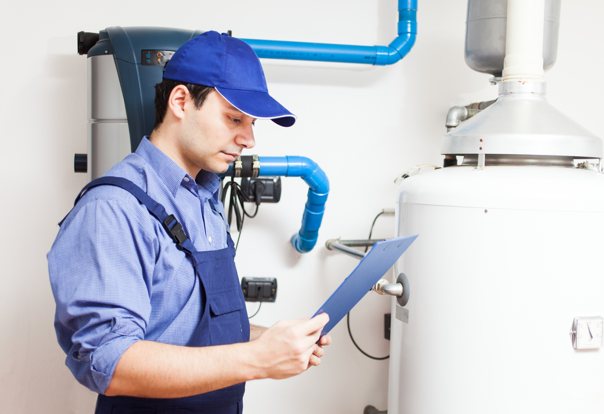  Smiling technician repairing an hot-water heater 